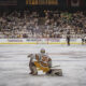 ASU hockey player in front of a packed student section at Mullet Arena.