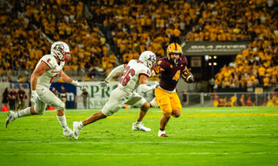 Cameron Skattebo stiff arms a Southern Utah defender.