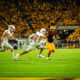 Cameron Skattebo stiff arms a Southern Utah defender.