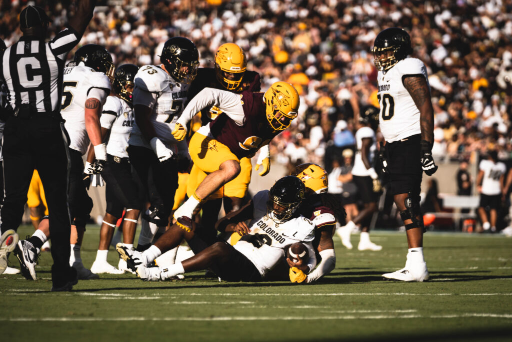 An Arizona State player making a tackle against Colorado.