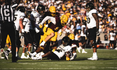 An Arizona State player making a tackle against Colorado.