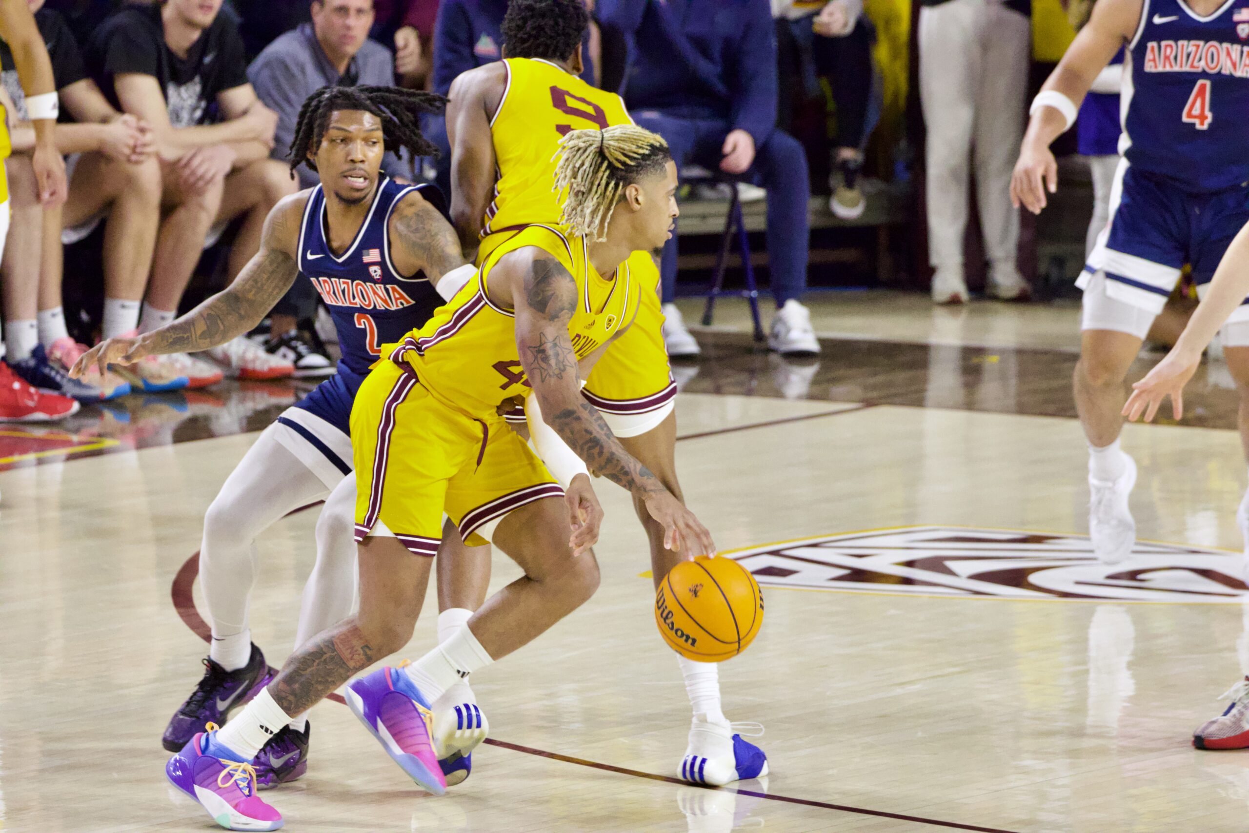 Arizona State basketball player Adam Miller dribbles against Arizona.