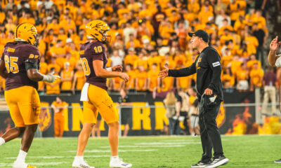 Kenny Dillingham and Sam Leavitt of ASU football talk on the sideline against Wyoming.