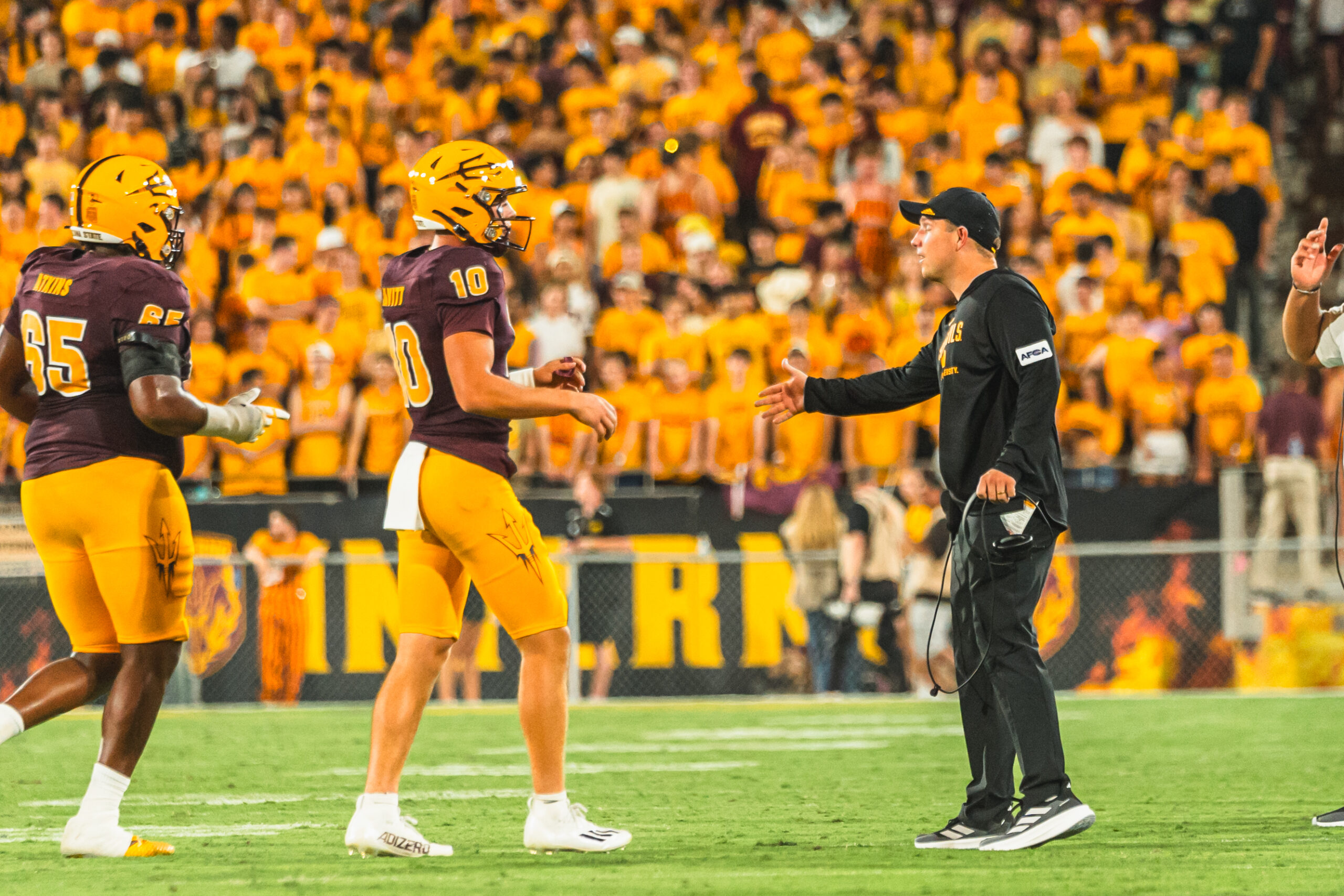 Kenny Dillingham and Sam Leavitt of ASU football talk on the sideline against Wyoming.