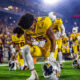 An ASU football player kneels before the Sun Devils' game against Mississippi State.