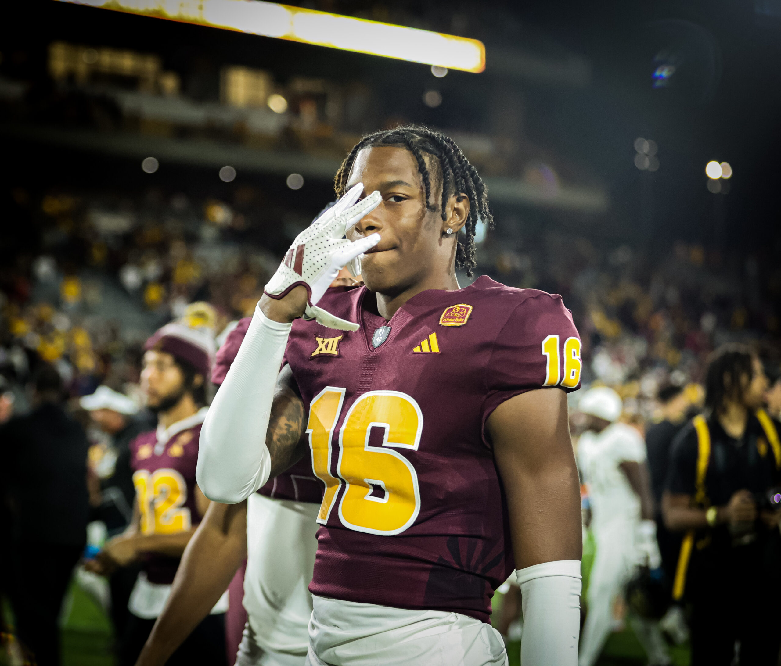 An Arizona State football player flashes "Forks Up" after a win over UCF.