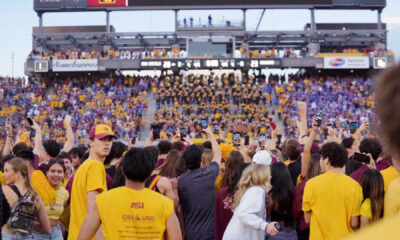 ASU football fans storm the field following a win over BYU.