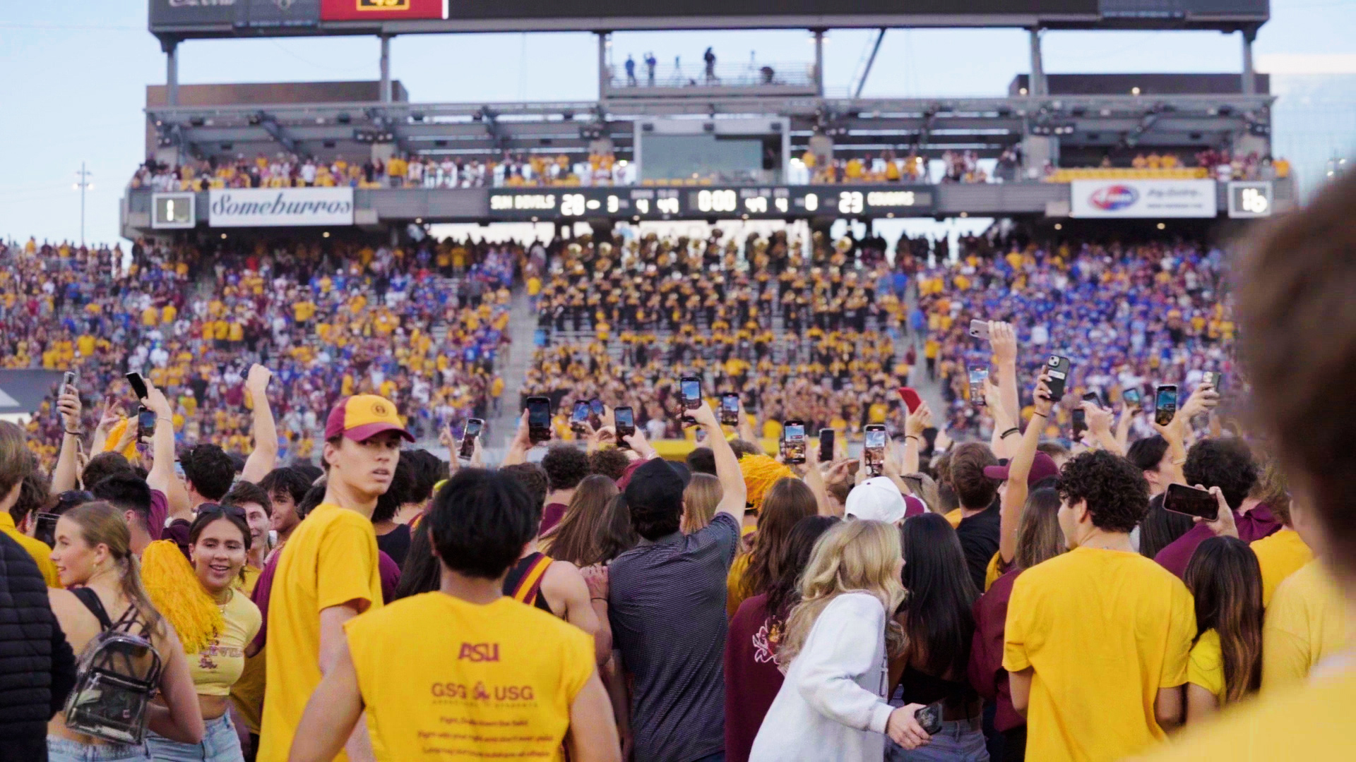 ASU football fans storm the field following a win over BYU.