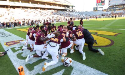 ASU football players huddle pregame.