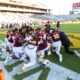 ASU football players huddle pregame.