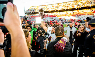 Arizona State's Cam Skattebo hoists the Territorial Cup after a win at Arizona Stadium on Nov. 30, 2024. The Territorial Cup Trophy is annually given to the winning team in the rivalry showdown between Arizona State and Arizona. (Photo by Sedona Levy/Sun Devil Daily)