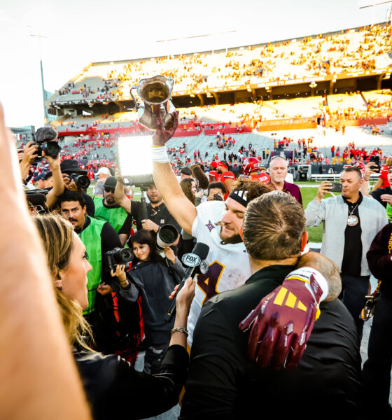 Arizona State's Cam Skattebo hoists the Territorial Cup after a win at Arizona Stadium on Nov. 30, 2024. The Territorial Cup Trophy is annually given to the winning team in the rivalry showdown between Arizona State and Arizona. (Photo by Sedona Levy/Sun Devil Daily)