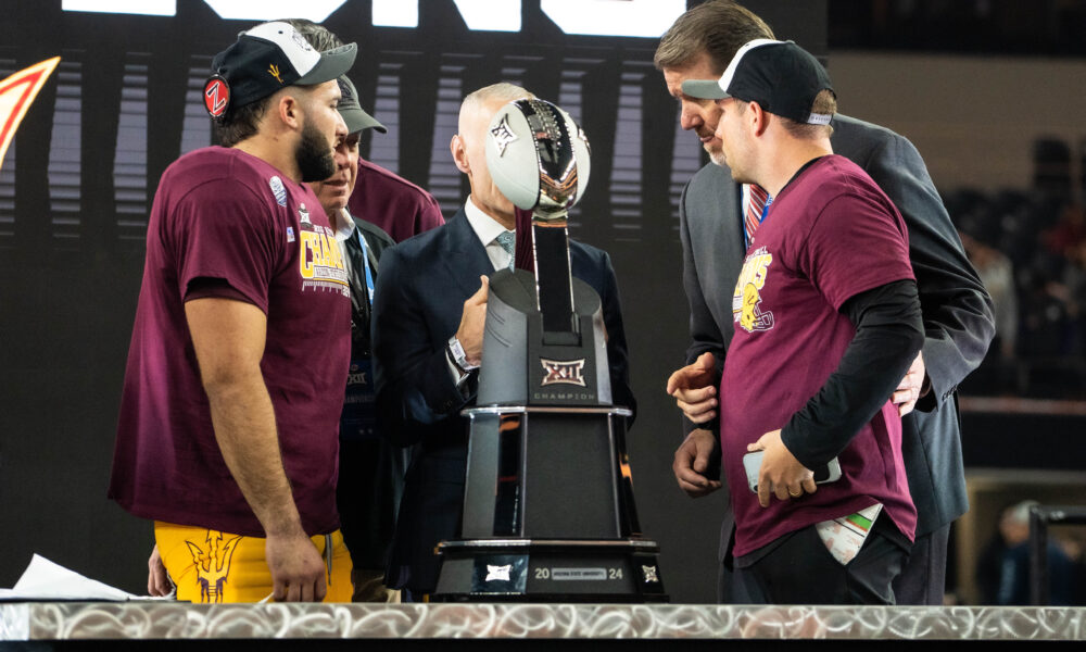 Arizona State running back Cam Skattebo (left of trophy) and coach Kenny Dillingham (right of trophy) accept the Big 12 Championship Trophy at AT&T Stadium on Dec. 7, 2024. (Photo by Truitt Robinson/Sun Devil Daily)