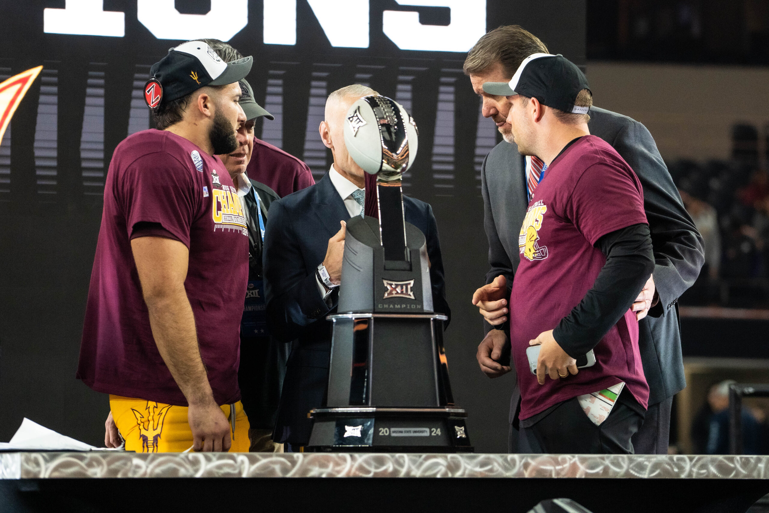 Arizona State running back Cam Skattebo (left of trophy) and coach Kenny Dillingham (right of trophy) accept the Big 12 Championship Trophy at AT&T Stadium on Dec. 7, 2024. (Photo by Truitt Robinson/Sun Devil Daily)