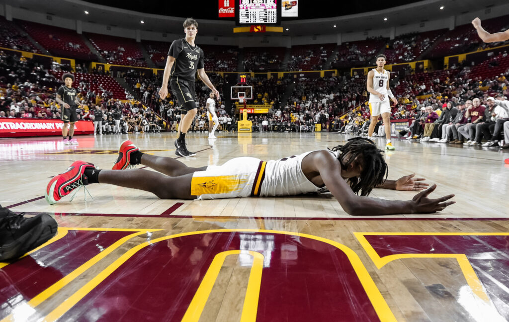 Jayden Quaintance looks up at a referee after being knocked to the hardwood against UCF on Jan. 14, 2025. (Photo by Sedona Levy/Sun Devil Daily)