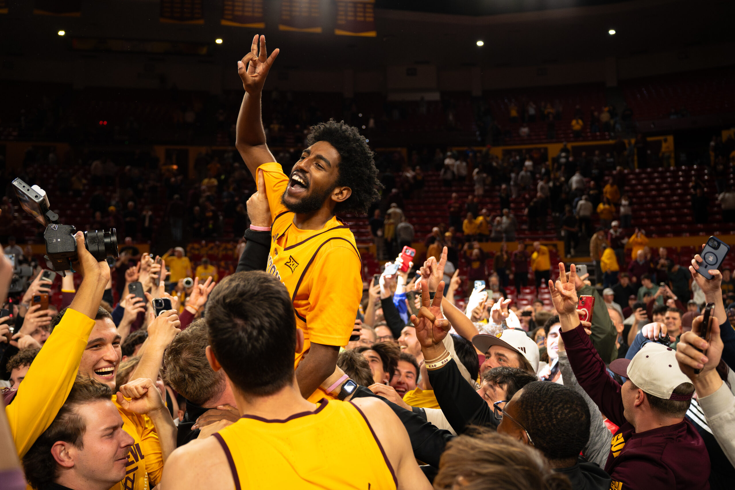 Moe Odum celebrates with students following ASU's victory over No. 13 TTU